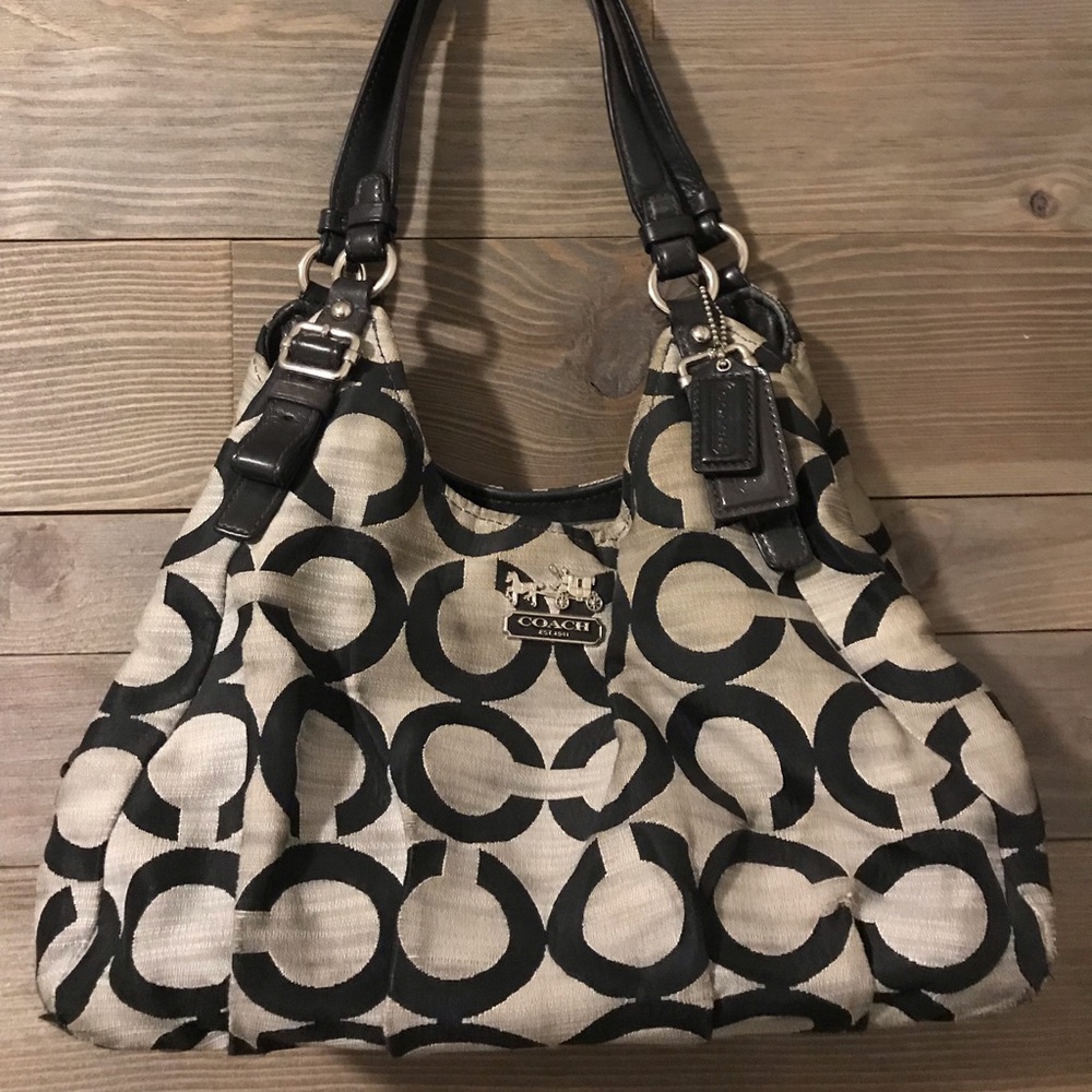 Medium/large Coach purse with three compartments.